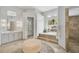 Bathroom with soaking tub, walk-in shower, and modern finishes at 854 Macewen Dr, Osprey, FL 34229