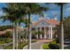 Grand entrance to a luxurious community with palm trees at 854 Macewen Dr, Osprey, FL 34229