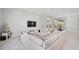 Spacious living room with large sectional sofa and views to the pool at 854 Macewen Dr, Osprey, FL 34229