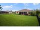 Green grassy backyard with home and fence at 409 147Th Ne Ct, Bradenton, FL 34212