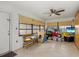 A sunroom with lots of natural light from the large windows, tile flooring, and a ceiling fan at 1017 Waterside St, Port Charlotte, FL 33952