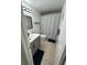 Clean bathroom with gray vanity, white sink, and decorative shower curtain at 1105 58Th S St, Gulfport, FL 33707