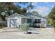 Charming single-story home featuring a well-maintained front yard with stone landscaping and a turquoise front door at 1105 58Th S St, Gulfport, FL 33707