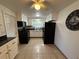 Bright kitchen with white cabinets, black appliances, and tile floor at 1105 58Th S St, Gulfport, FL 33707