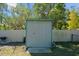 Grey storage shed with single door in backyard at 1105 58Th S St, Gulfport, FL 33707