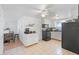 Galley style kitchen with white cabinets, black appliances, and ample counter space at 1105 58Th S St, Gulfport, FL 33707