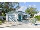 Charming light blue home with a stone facade and gravel driveway at 1105 58Th S St, Gulfport, FL 33707