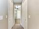 Clean hallway with access to two doors, leading to the bathroom at 144 Pescador Pl, Nokomis, FL 34275