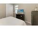 Bedroom with a queen bed, dresser, and TV at 144 Pescador Pl, Nokomis, FL 34275