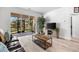 Living room with leather sofa and sliding doors to screened patio at 146 51St Street E Cir, Palmetto, FL 34221