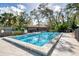 Community pool with a spa and plenty of lounge chairs for relaxation at 1590 Suwanee Ct, Sarasota, FL 34232