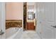 Bathroom with soaking tub, shower, and granite vanity at 1900 Colleen St, Sarasota, FL 34231