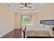 Spacious bedroom featuring hardwood floors, ceiling fan, neutral colors, and sliding door to backyard at 1900 Colleen St, Sarasota, FL 34231