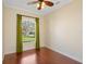 Comfortable bedroom with hardwood floors, natural light from window, and neutral colored walls at 1900 Colleen St, Sarasota, FL 34231