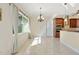 Bright dining area featuring tile floors, modern light fixture, and large window providing ample natural light at 1900 Colleen St, Sarasota, FL 34231