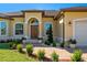 Charming front entrance with a decorative doorway, manicured landscaping, and a brick pathway at 1900 Colleen St, Sarasota, FL 34231