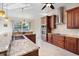 Gourmet kitchen with granite countertops, custom cabinetry, stainless steel appliances, and tile flooring at 1900 Colleen St, Sarasota, FL 34231