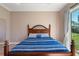 Bedroom with wood floors and blue striped bedding at 1900 Colleen St, Sarasota, FL 34231