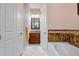 Bathroom with soaking tub and shower, and granite vanity at 1900 Colleen St, Sarasota, FL 34231
