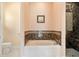 Bathroom with soaking tub, shower, and marble accents at 1900 Colleen St, Sarasota, FL 34231