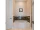 Bathroom with soaking tub and marble tile accents at 1900 Colleen St, Sarasota, FL 34231