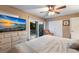 Main bedroom with king bed, dresser, balcony access and sunset view at 2105 Riverview Blvd, Bradenton, FL 34205