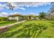 Single story home with landscaped yard and walkway at 29205 Saddlebag Trl, Myakka City, FL 34251
