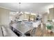 Open kitchen with granite counters, farmhouse sink, and stainless steel appliances at 29205 Saddlebag Trl, Myakka City, FL 34251