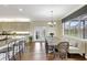 Kitchen dining area with a long farmhouse table and a view to backyard at 29205 Saddlebag Trl, Myakka City, FL 34251