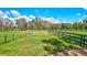 Open pasture with a wooden fence and gate at 29205 Saddlebag Trl, Myakka City, FL 34251