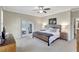 Main bedroom with king bed, access to patio, and wood dresser at 29205 Saddlebag Trl, Myakka City, FL 34251