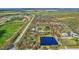 Aerial view of a house with a large lot and pond at 29205 Saddlebag Trl, Myakka City, FL 34251