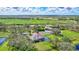 Aerial view of the property, including home, pool, and outbuildings at 29205 Saddlebag Trl, Myakka City, FL 34251