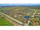 Aerial view of property showcasing home, pond, and expansive land at 29205 Saddlebag Trl, Myakka City, FL 34251