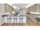 Modern kitchen with granite countertops, stainless steel appliances, and breakfast bar at 29205 Saddlebag Trl, Myakka City, FL 34251