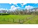 Spacious pasture with wooden fence and lush grass at 29205 Saddlebag Trl, Myakka City, FL 34251