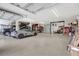 Large garage with car lift and ample storage at 29205 Saddlebag Trl, Myakka City, FL 34251