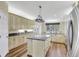 Open kitchen with granite island, custom cabinetry, and stainless steel appliances at 29205 Saddlebag Trl, Myakka City, FL 34251