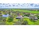 Aerial view of home with pool, fenced pasture and pond at 29205 Saddlebag Trl, Myakka City, FL 34251