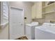 Convenient laundry room with washer, dryer, and cabinets at 29205 Saddlebag Trl, Myakka City, FL 34251