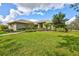Single story home with landscaped yard and walkway at 29205 Saddlebag Trl, Myakka City, FL 34251