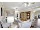 Open concept living room with hardwood floors, built-in shelving, and a view to the kitchen at 29205 Saddlebag Trl, Myakka City, FL 34251