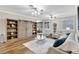 Open living room with hardwood floors, built-in shelving, and a cozy seating area at 29205 Saddlebag Trl, Myakka City, FL 34251