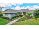 Single-story home with landscaped yard and walkway at 29205 Saddlebag Trl, Myakka City, FL 34251