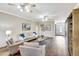 Bright living room with hardwood floors, neutral decor, and comfortable seating at 29205 Saddlebag Trl, Myakka City, FL 34251