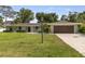 Ranch home with a well-manicured lawn and attached garage at 322 Suwanee Ave, Sarasota, FL 34243