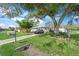 Ranch style home with a large tree and a car parked in the driveway at 4457 Brooksdale Dr, Sarasota, FL 34232