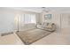 Living room with a beige couch, floor lamp, and area rug at 4457 Brooksdale Dr, Sarasota, FL 34232