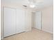 Well-lit bedroom with tile flooring and double-door closet at 4457 Brooksdale Dr, Sarasota, FL 34232