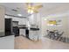 Galley kitchen with white cabinets, black appliances, and granite countertops at 4457 Brooksdale Dr, Sarasota, FL 34232